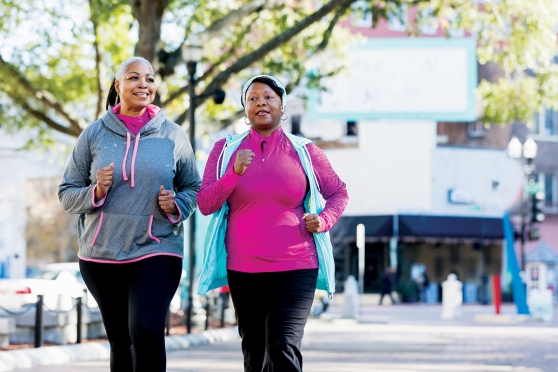 Two women walking beside each other in athleisure wear.