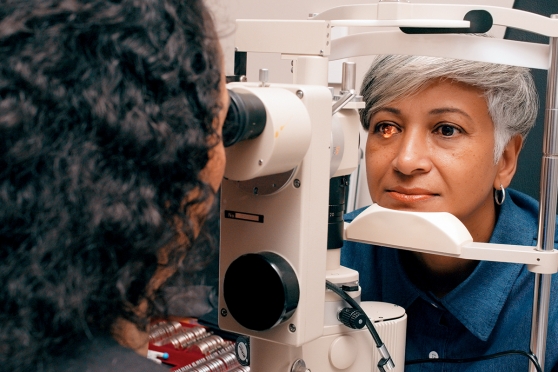 A woman gets her eyes examined at the optometrist's office.